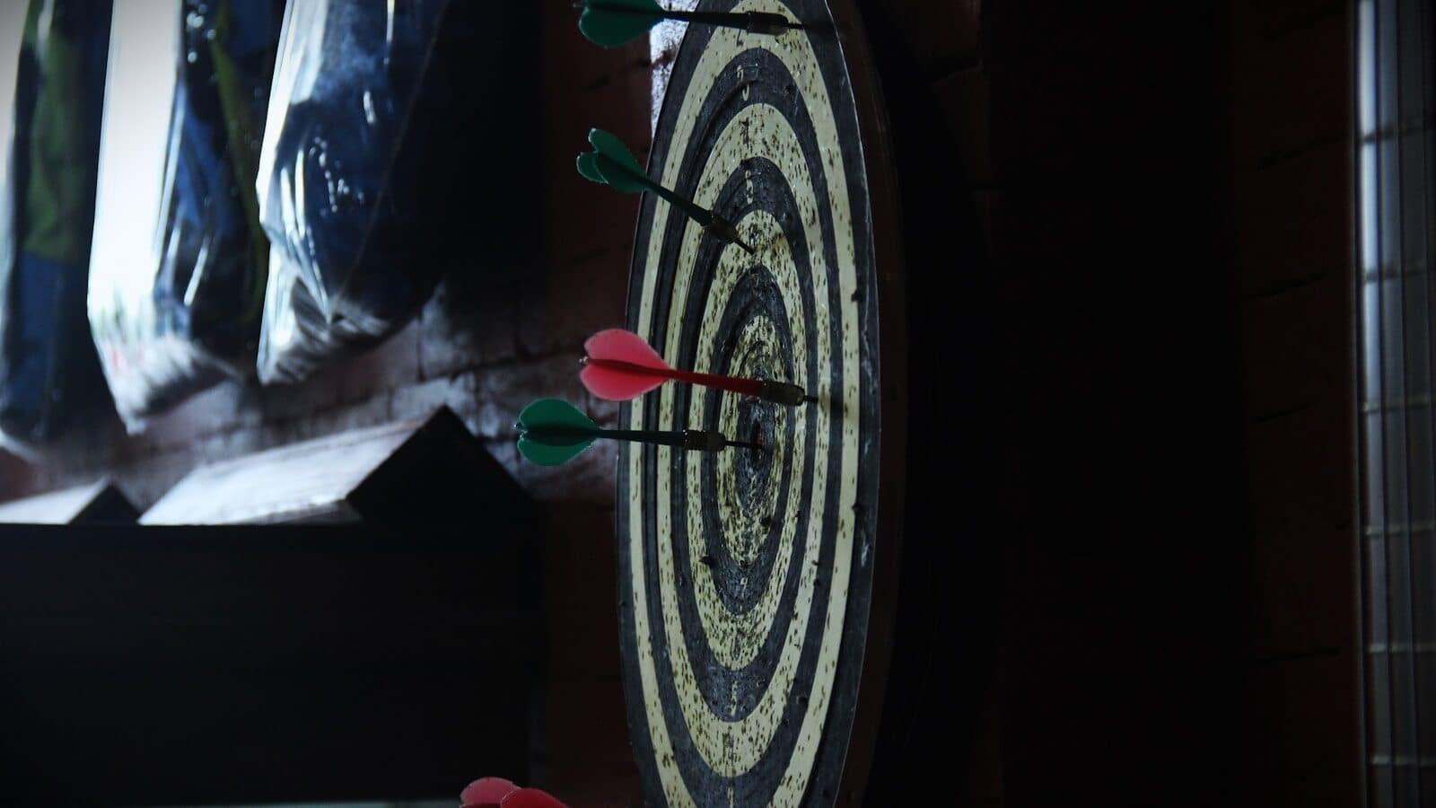 a close up of a dart board with arrows on it